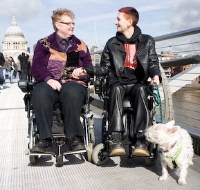 Colour photograph of Julie and Ju holding hands on the Millennium Bridge
