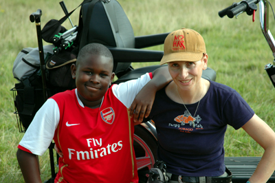 Colour photograph of Seun and I sitting in front of my scooter, smiling at the camera.