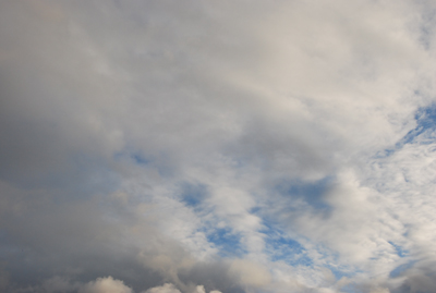 Colour photograph of rain clouds covering a blue sky