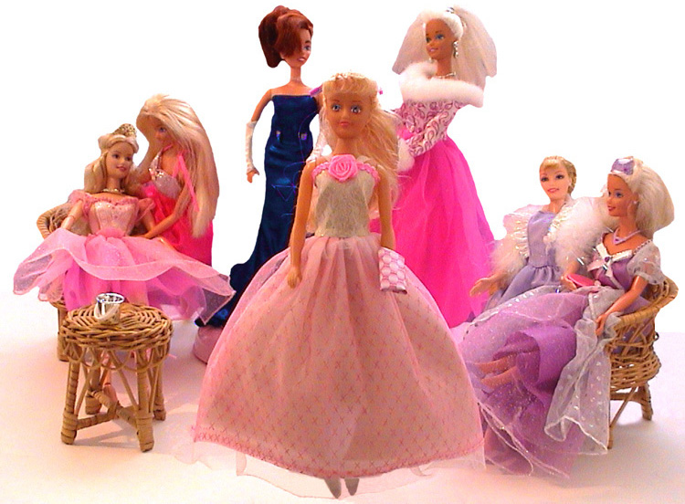 A fashion doll in a ballgown faces front against a white background. Behind her a group of fashion dolls dressed in party clothes are drinking and socialising.