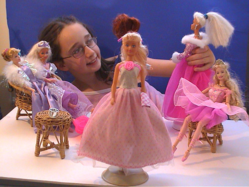 Photograph of a girl setting up the dolls for the photoshoot
