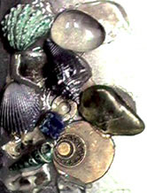 Close-up photograph of crystals, shells etc on the front of Ju's brace